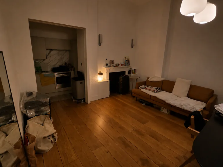 A warm interior with a small crystal lamp casting patterned light near a fireplace